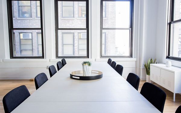 An empty conference table with chairs