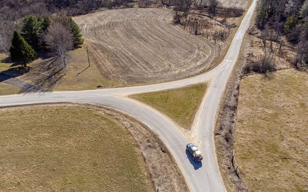 A car approaching a fork in a country road