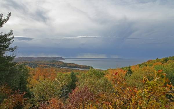 Fall color on wooded hills above a lake
